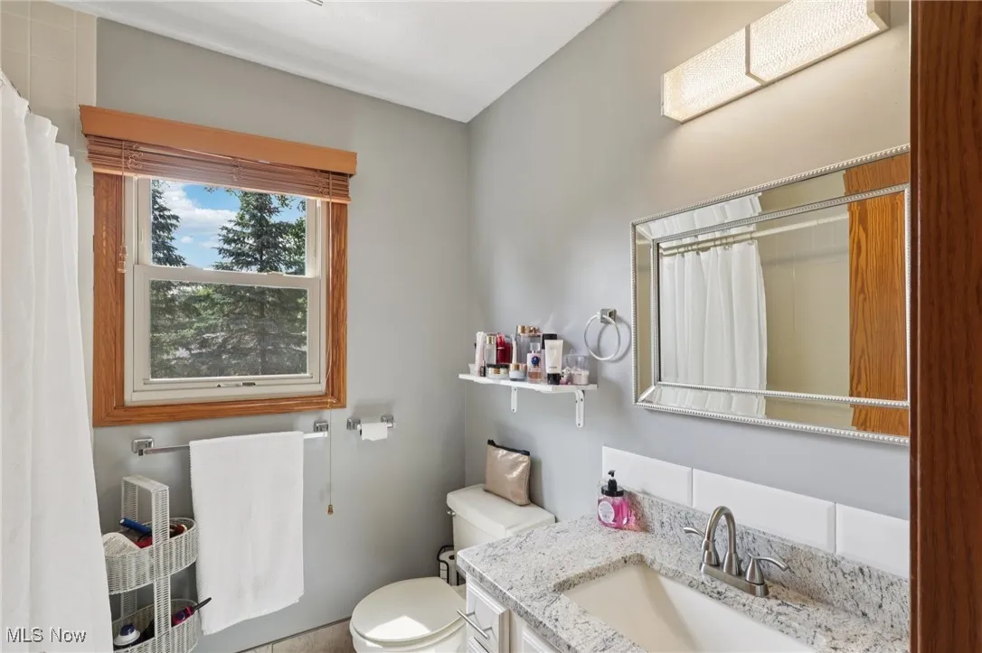 Bathroom featuring vanity and a shower