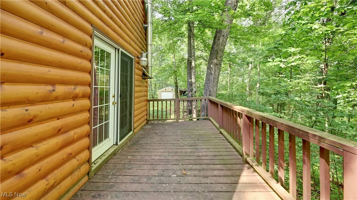 Deck with french doors and an outbuilding