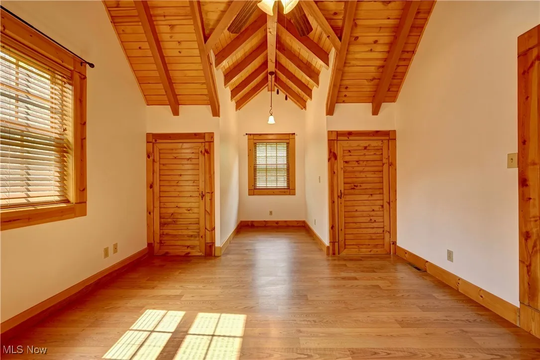 Spare room with wood ceiling and light wood finished floors