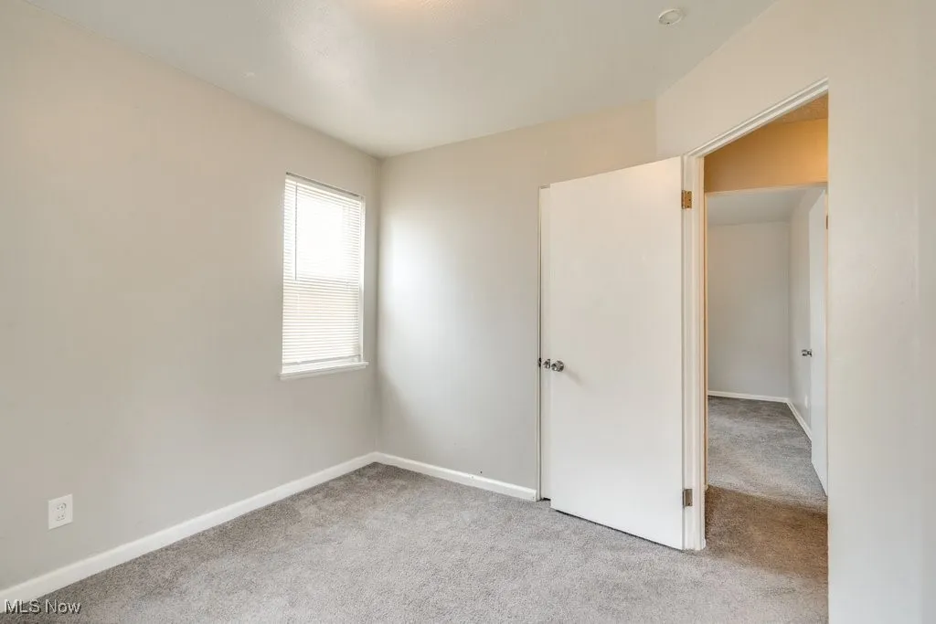 Unfurnished bedroom with carpet flooring