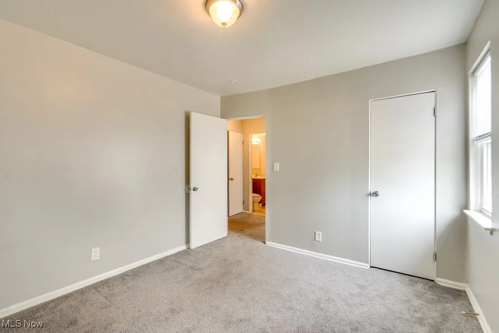 Unfurnished bedroom featuring carpet flooring