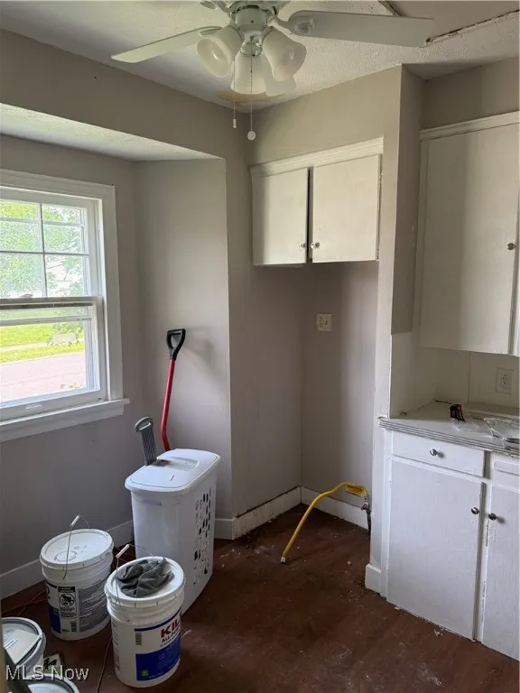 Misc room with dark wood finished floors and ceiling fan