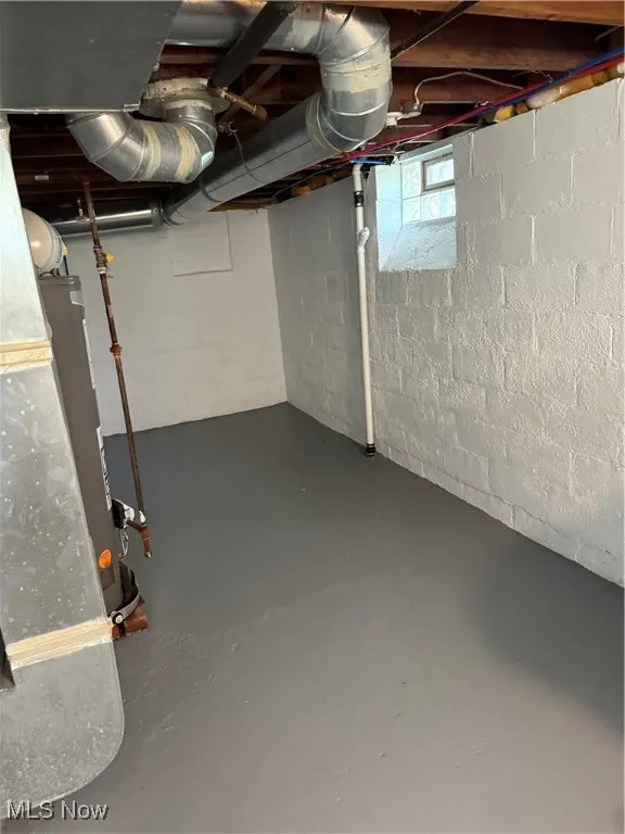 Basement featuring heating unit