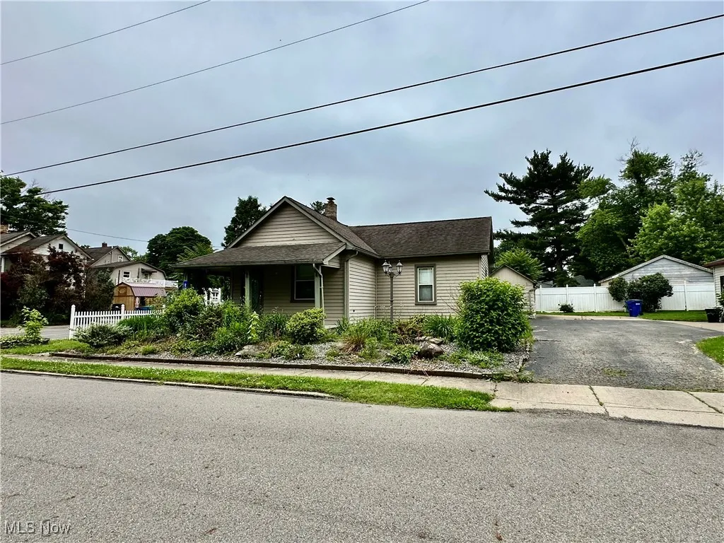 Bungalow with a chimney and asphalt driveway