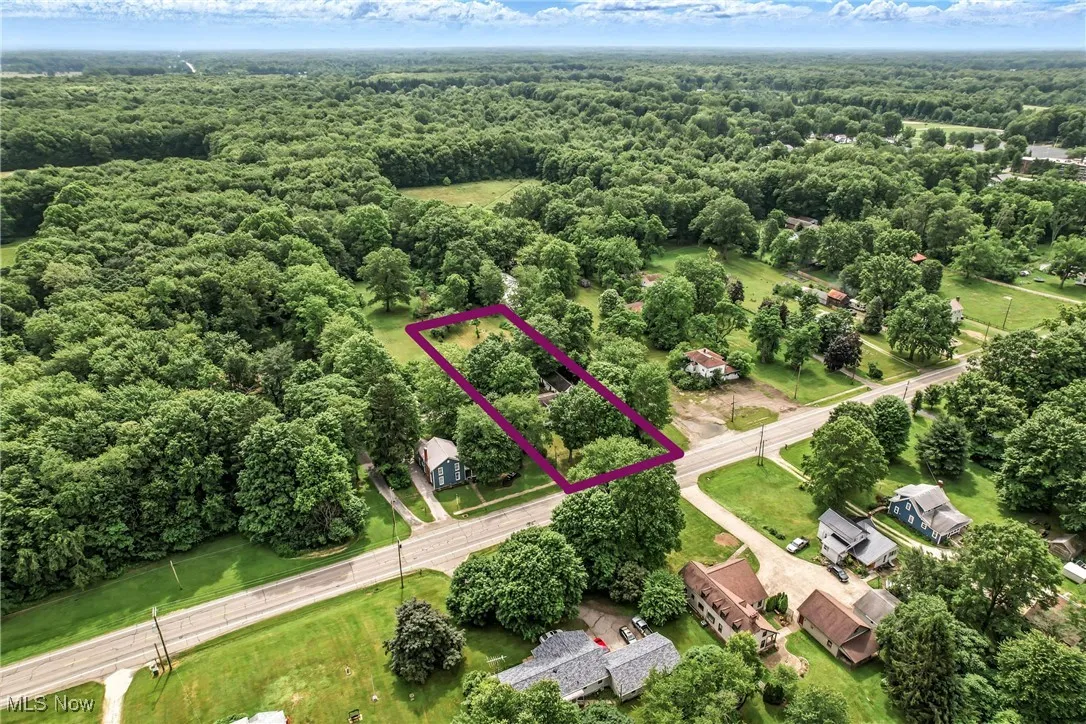 Aerial overview of property's location featuring a forest and property parcel outlined