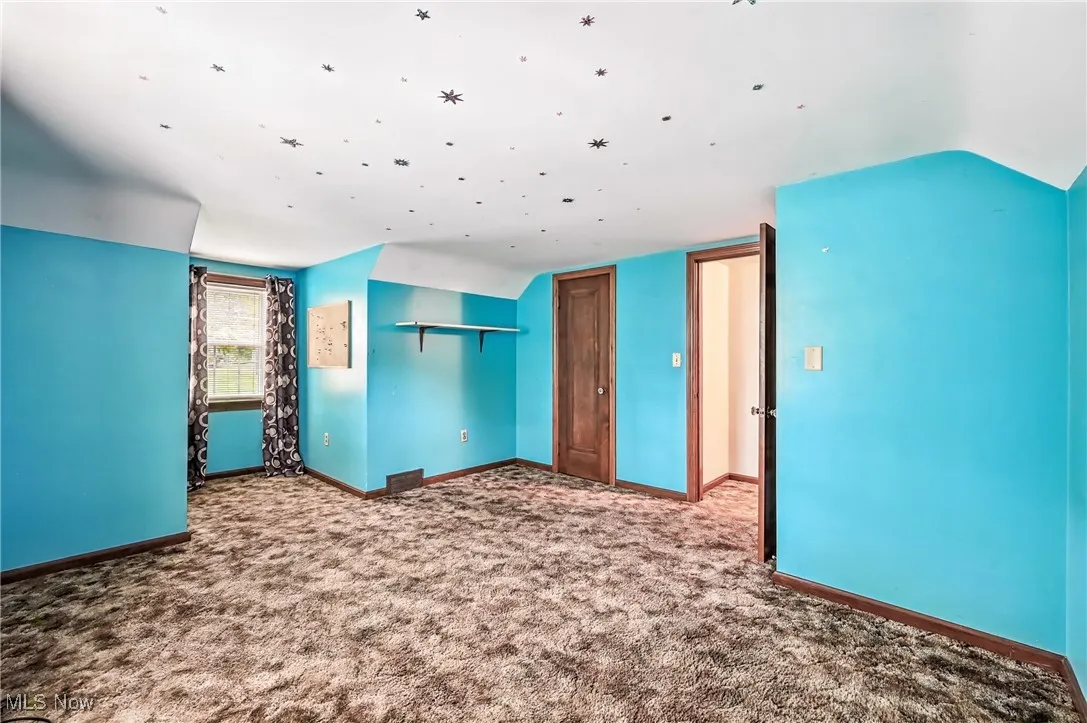 Unfurnished bedroom featuring carpet and a closet