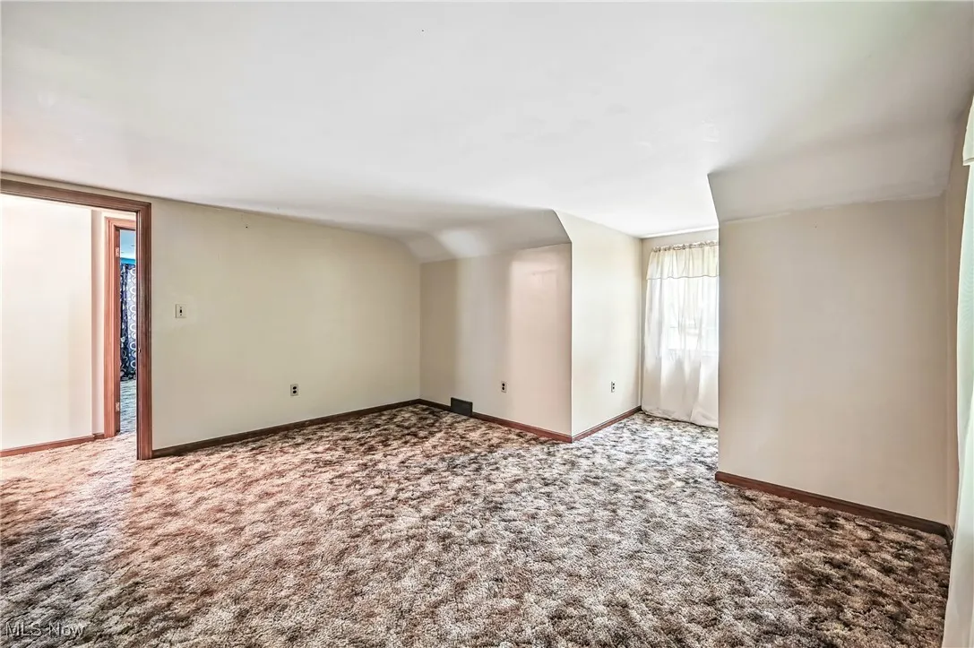Unfurnished room featuring carpet flooring