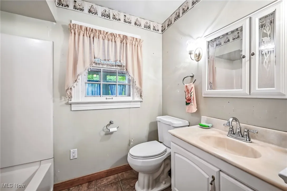 Bathroom with vanity and baseboards