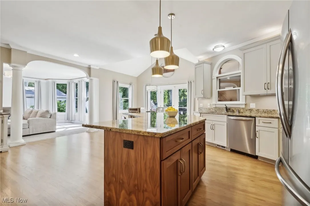 Large Center Island offers Granite & Extra Storage with Pendant Lighitng
