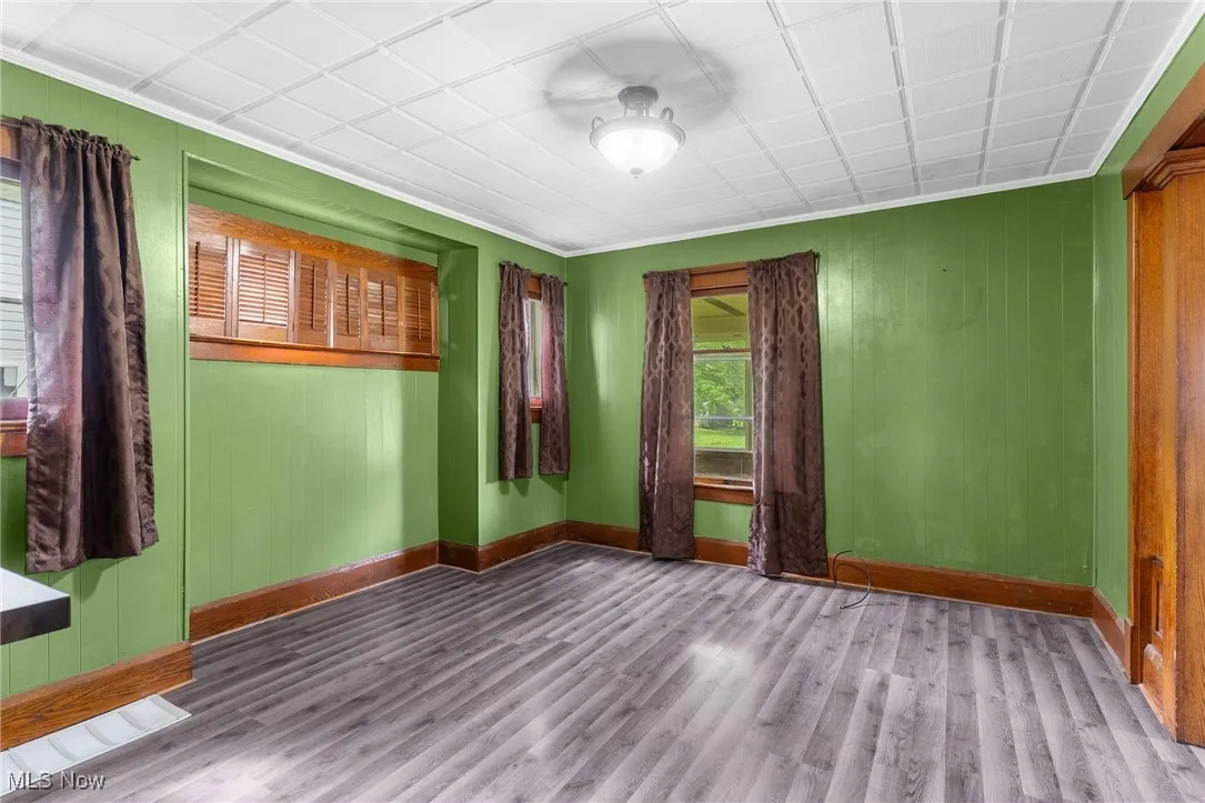 Spare room with wood finished floors and ornamental molding