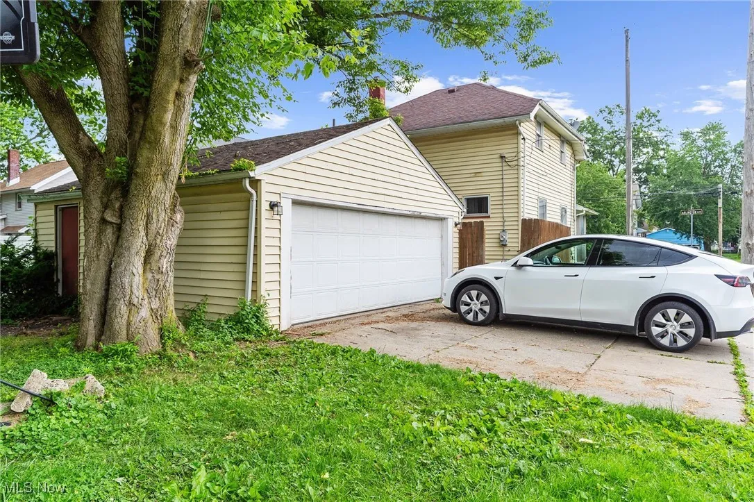 View of side of home featuring a detached garage