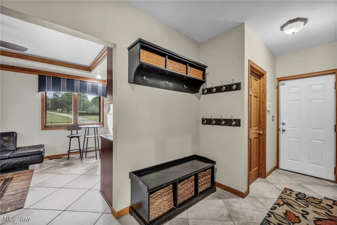 Mudroom with light tile patterned floors