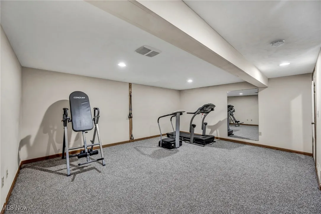 Workout area with carpet floors and recessed lighting