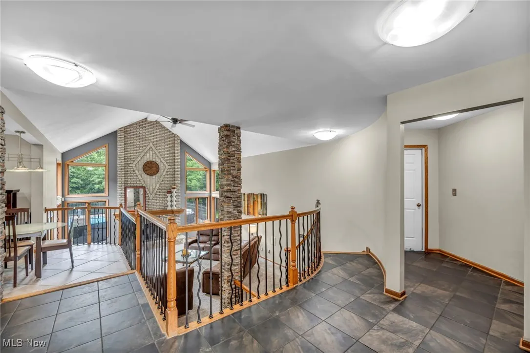 Hall with an upstairs landing and vaulted ceiling