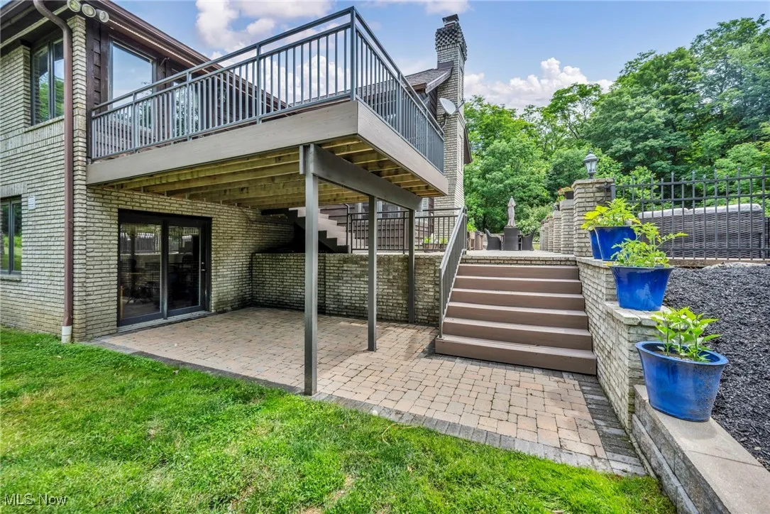 walkout basement View of patio featuring stairs and a wooden deck