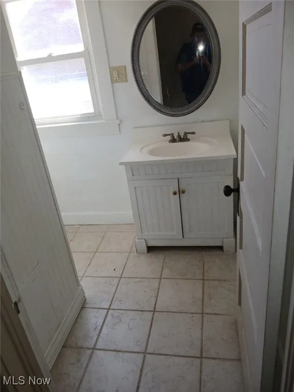 Bathroom featuring vanity and baseboards