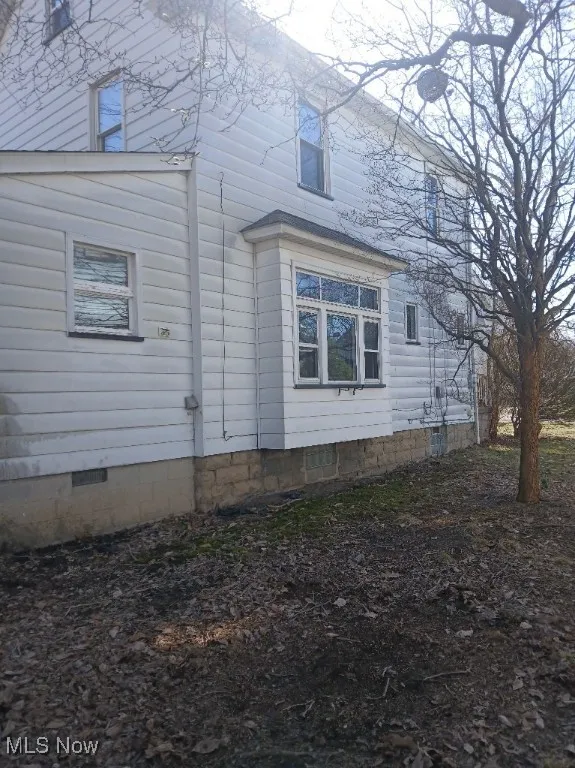 View of property exterior with crawl space