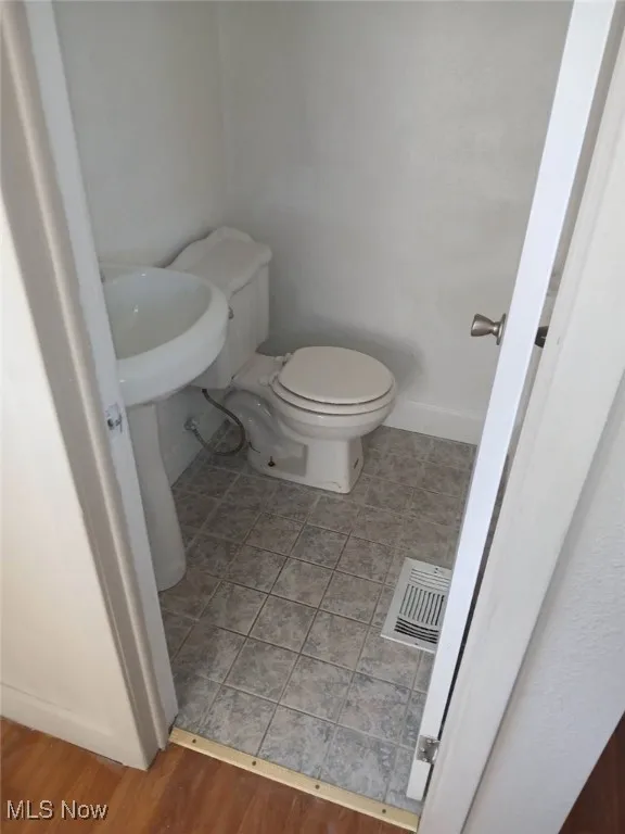 Bathroom featuring toilet and tile patterned floors