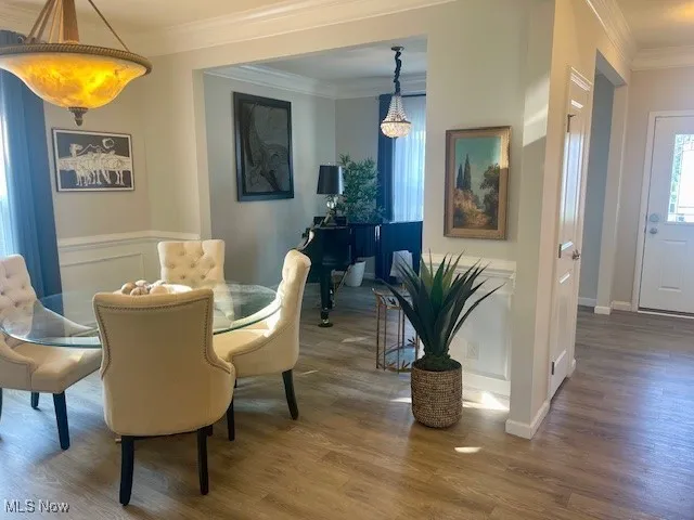 The formal dining room is a true showstopper, featuring exquisite wainscoting panels, a tasteful chair rail, and crown molding that beautifully accentuate the 9-foot ceilings. This refined space sets the perfect stage for elegant dinners and memorable gatherings.