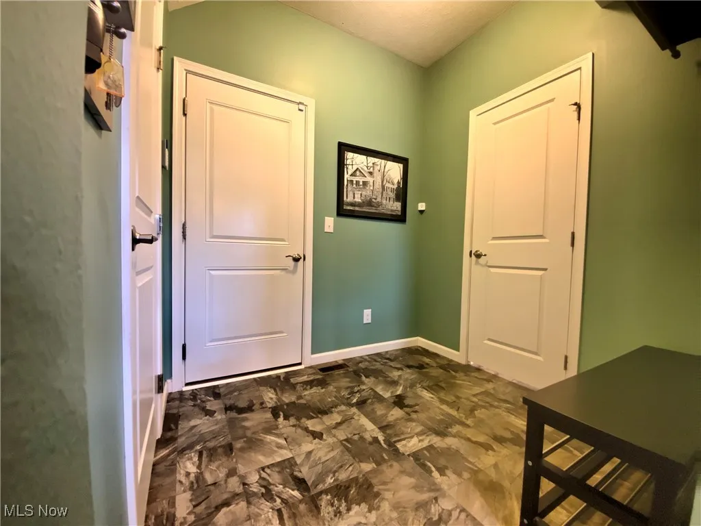 The practical mudroom entry from the garage makes coming and going a breeze. On one side, a convenient half bath is located just steps away, while the other side leads to the stairs that take you down to the lower level—providing easy access to additional living space. Whether you're hosting a game night, working out, or just relaxing, this space has it all. And if guests stay late, they'll feel right at home in the lower-level bedroom, complete with a luxurious steam shower bathroom for the ultimate comfort and privacy.
