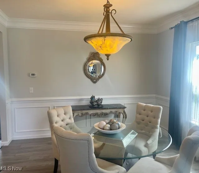 From the piano room, you can enjoy an elegant view into the formal dining room, where the rich wainscoting, chair rail, and crown molding enhance the sophisticated ambiance. The open flow between these two spaces creates a seamless transition, perfect for both intimate meals and larger gatherings.