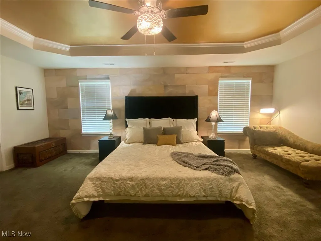 The spacious primary bedroom is a true retreat, featuring a stunning tray ceiling that adds depth and elegance to the room. Enjoy the luxury of two walk-in closets, offering ample space for storage and organization. The room seamlessly flows into a private en-suite bathroom, creating the perfect sanctuary for relaxation and rejuvenation.
