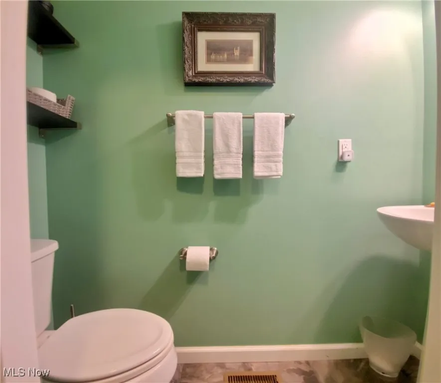 A thoughtfully placed half bath on the first floor adds both convenience and privacy, making it easy for guests to feel at home without having to venture upstairs.