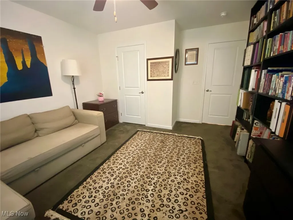 This second-floor bedroom, viewed from another angle, highlights a spacious closet and convenient doorway leading to the hallway, enhancing both storage and accessibility.

