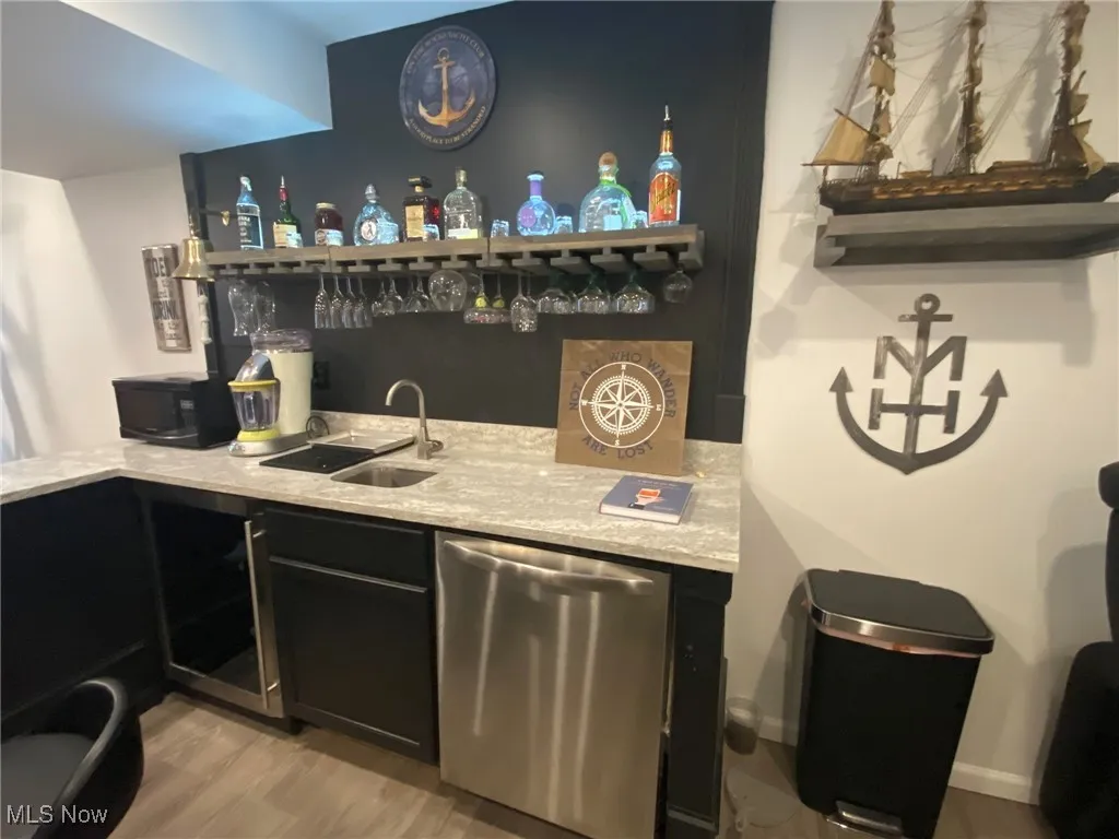 The lower-level wet bar is a perfect blend of convenience and luxury, featuring a built-in refrigerator and dishwasher, along with a sleek granite countertop. It’s the ideal setup for entertaining, making it easy to serve drinks and snacks while keeping everything organized and within reach.