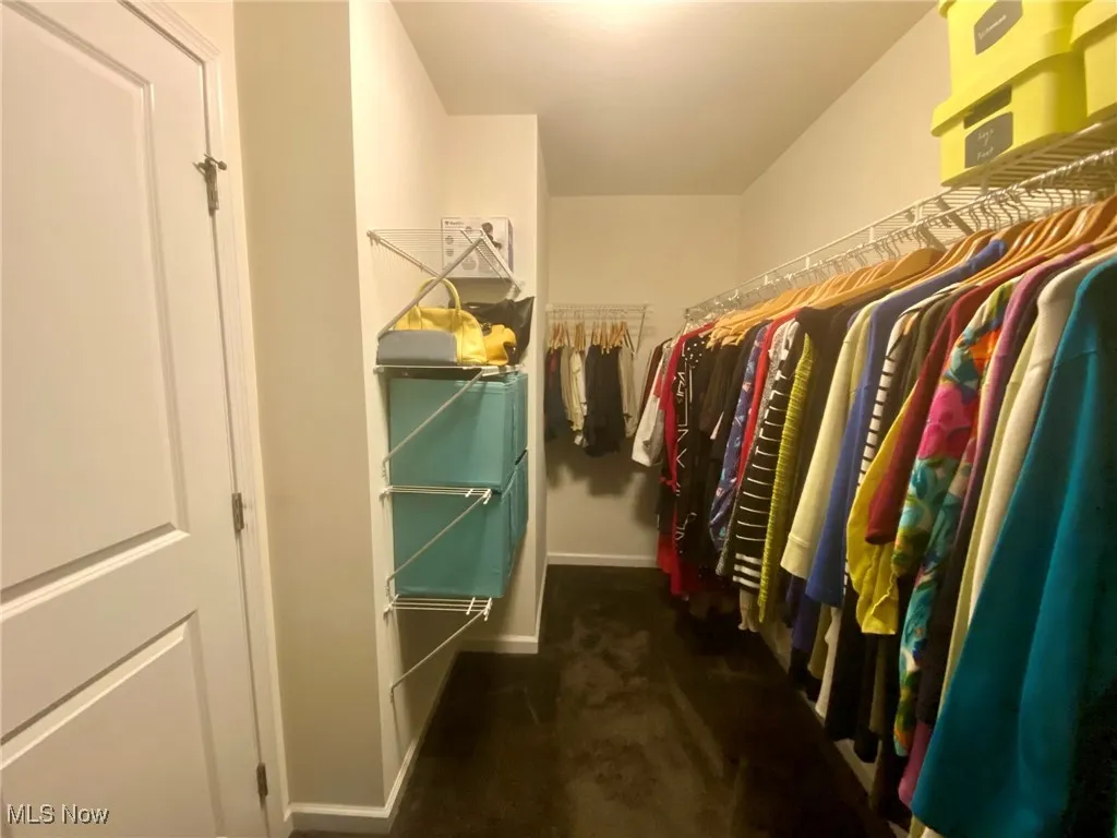 Step inside the first walk-in closet of the primary bedroom, where you'll find an expansive, well-organized space with plenty of room for your wardrobe. Thoughtfully designed with built-in shelving and ample hanging space, it’s a closet that combines both style and function, keeping everything easily accessible and perfectly arranged.