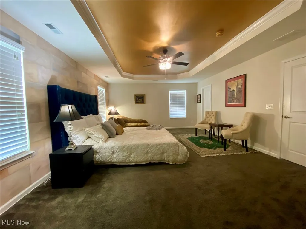 The expansive 21 ft. by 15 ft. primary bedroom is a true owner’s oasis, thoughtfully expanded during the original design phase to create a luxurious retreat. Featuring a striking tray ceiling, the room offers both style and space, while a door leads to a second walk-in closet—perfect for added storage and organization. It’s a serene sanctuary that combines comfort with elegance, designed for ultimate relaxation.