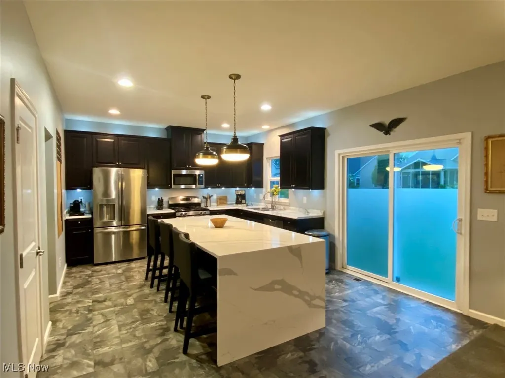 Island with quartz counter and waterfall edge.