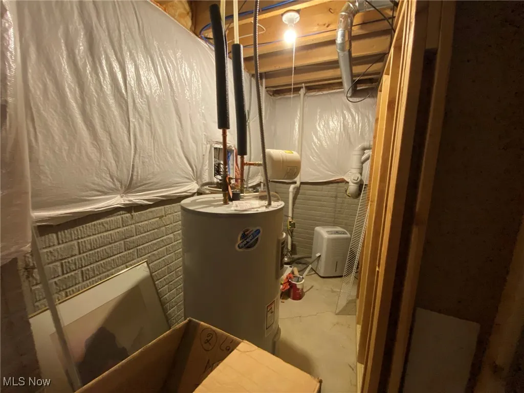 Discreetly located on the lower level, the utility room features a compact, well-organized mechanical nook that houses the furnace, water heater, and sump pump. Expertly designed to maximize space efficiency, this area keeps essential systems easily accessible.