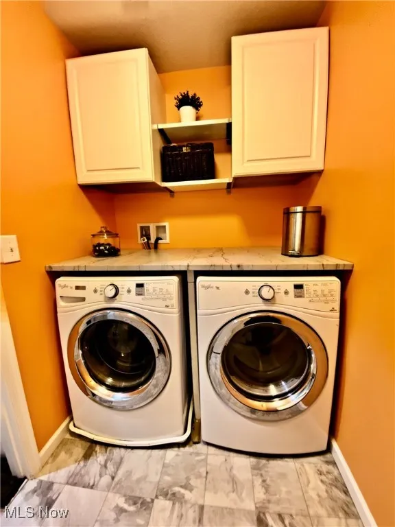 The second-floor laundry room is both stylish and functional, featuring elegant granite countertops and ample cabinetry for storage. This well-appointed space makes laundry tasks a breeze, offering convenience and organization right where you need it.