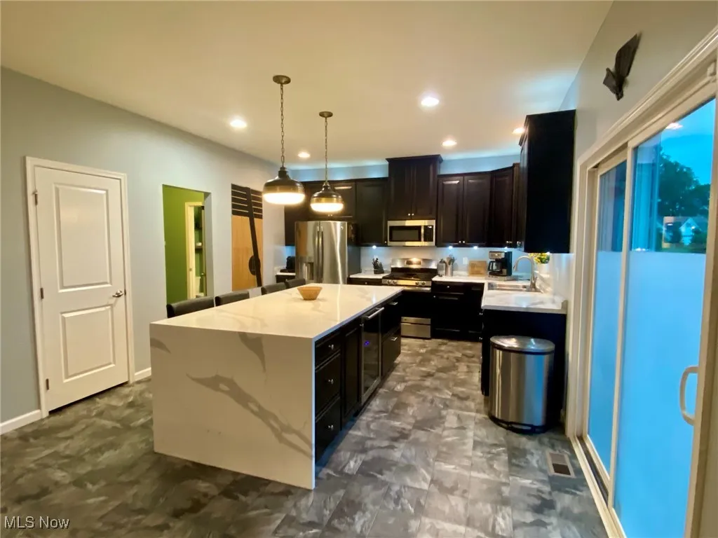 Island offers beverage cooler as well as storage.