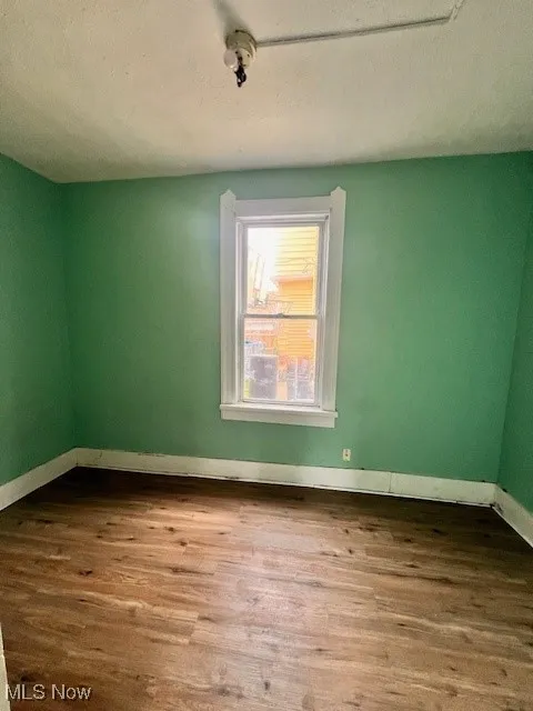 Empty room featuring wood finished floors