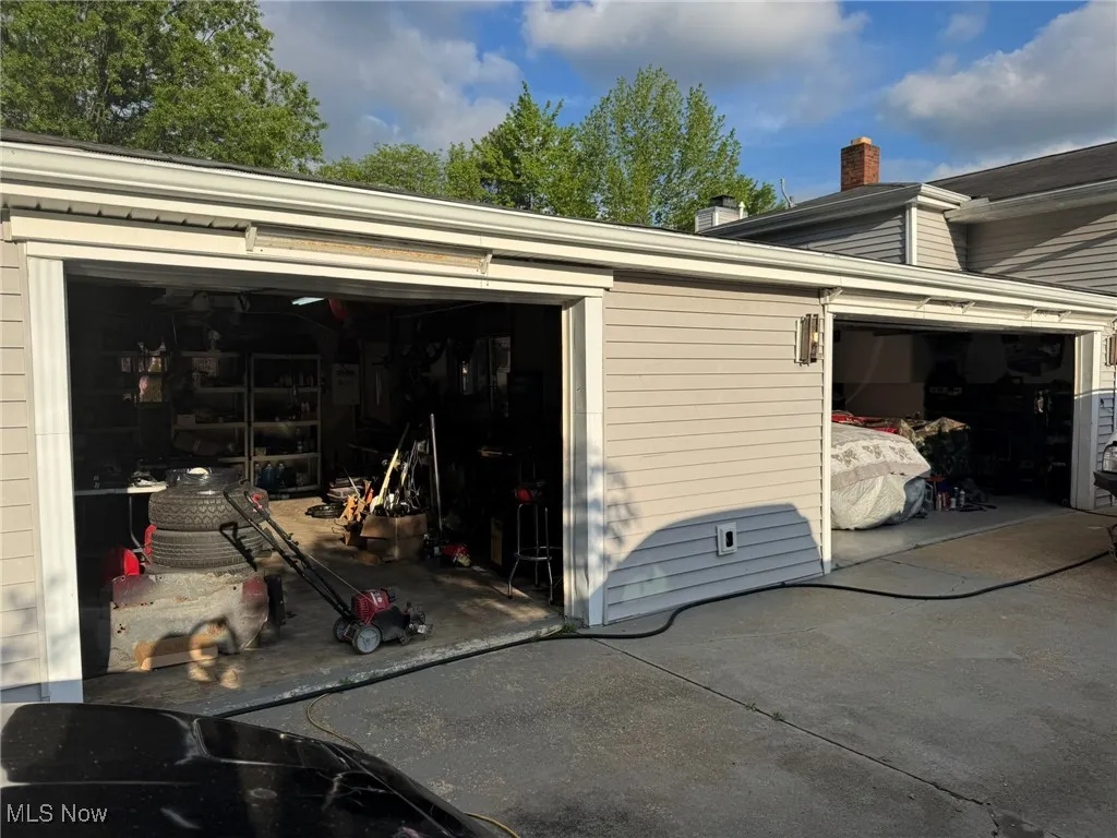 3 + car Garage featuring driveway