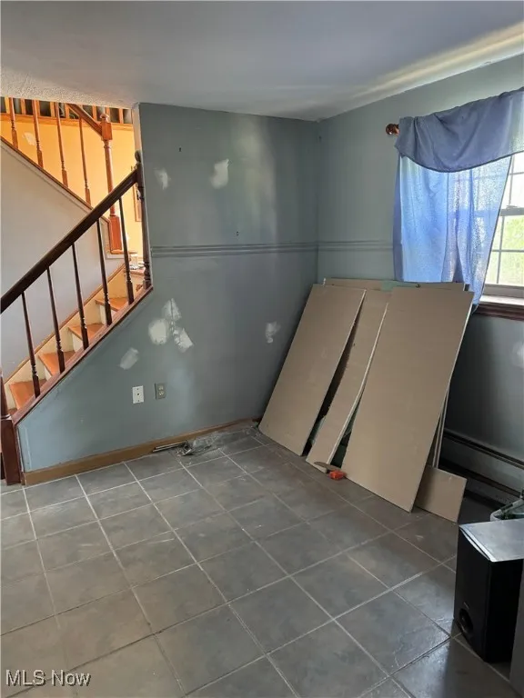Spare room with, tile patterned floors, and stairs