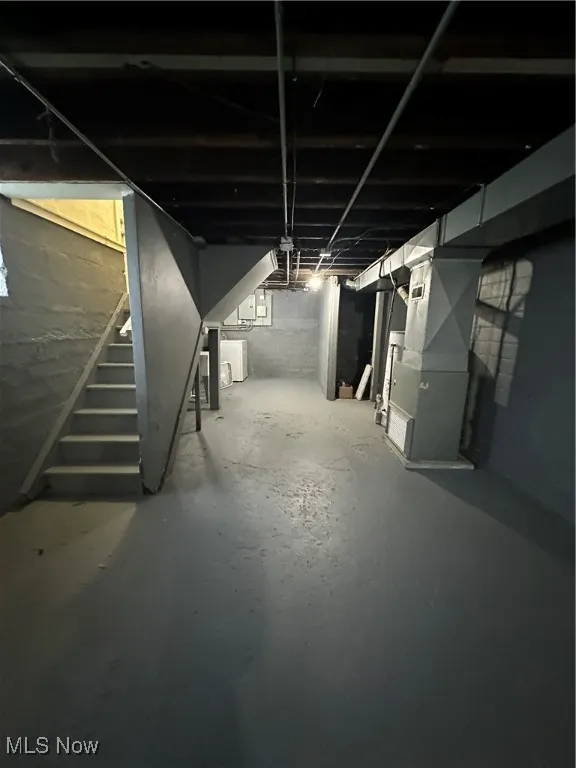 Basement featuring stairs and washer / dryer