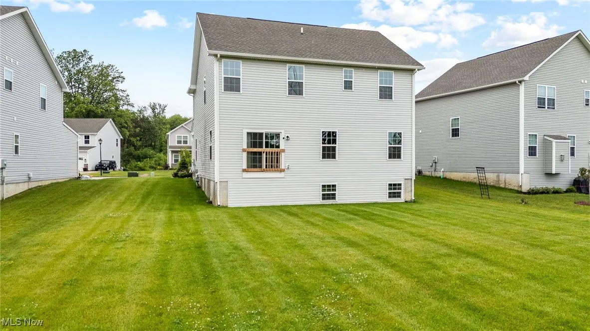 Back of house with a yard
