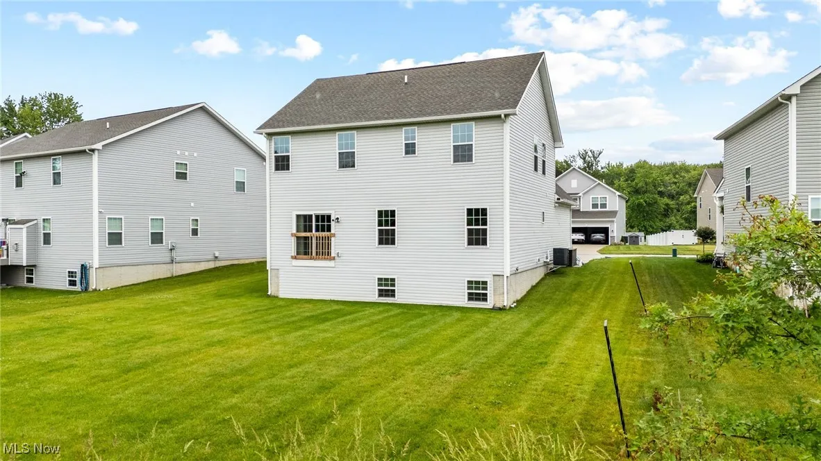Back of house featuring a yard
