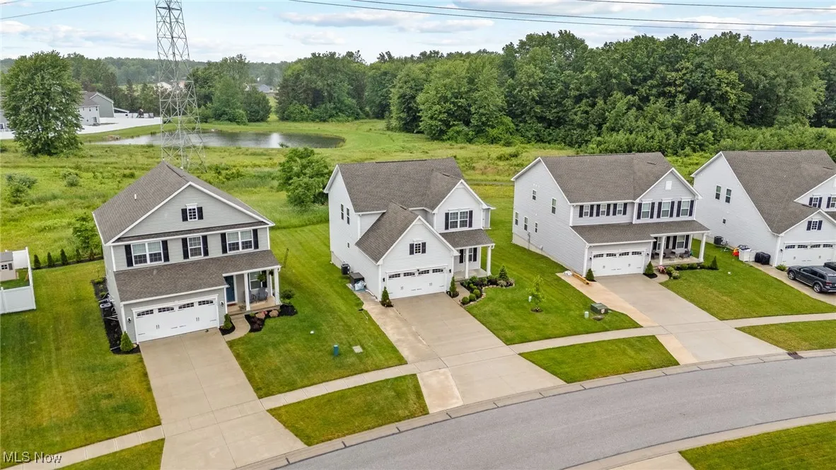 Aerial perspective of suburban area featuring a nearby body of water
