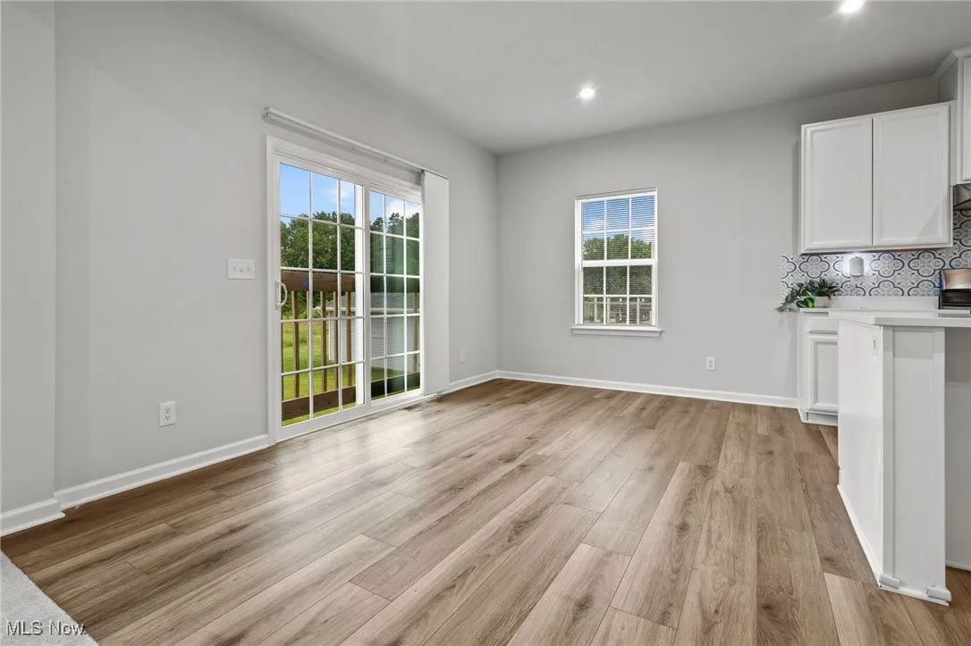 Unfurnished dining area featuring light wood finished floors and recessed lighting