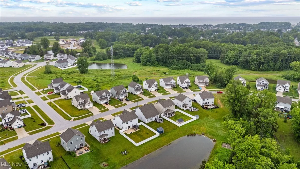 Aerial perspective of suburban area featuring a large body of water