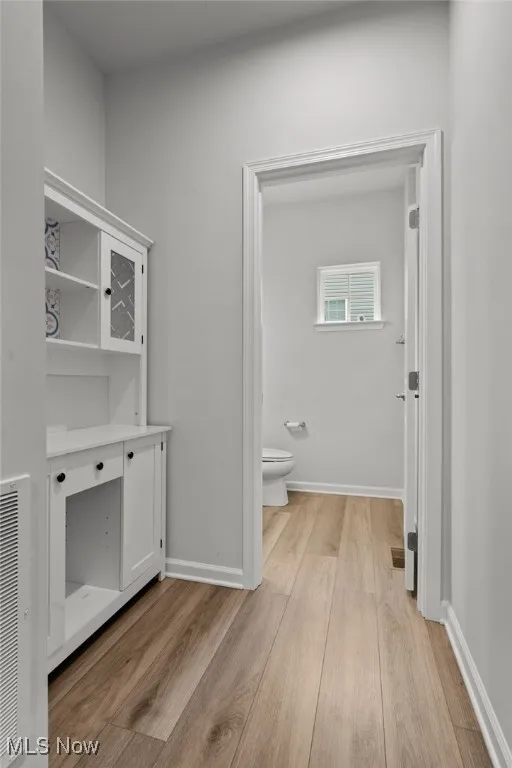 Bathroom with toilet and wood finished floors