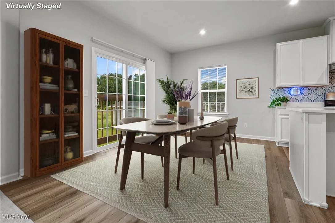Dining space featuring wood finished floors and recessed lighting