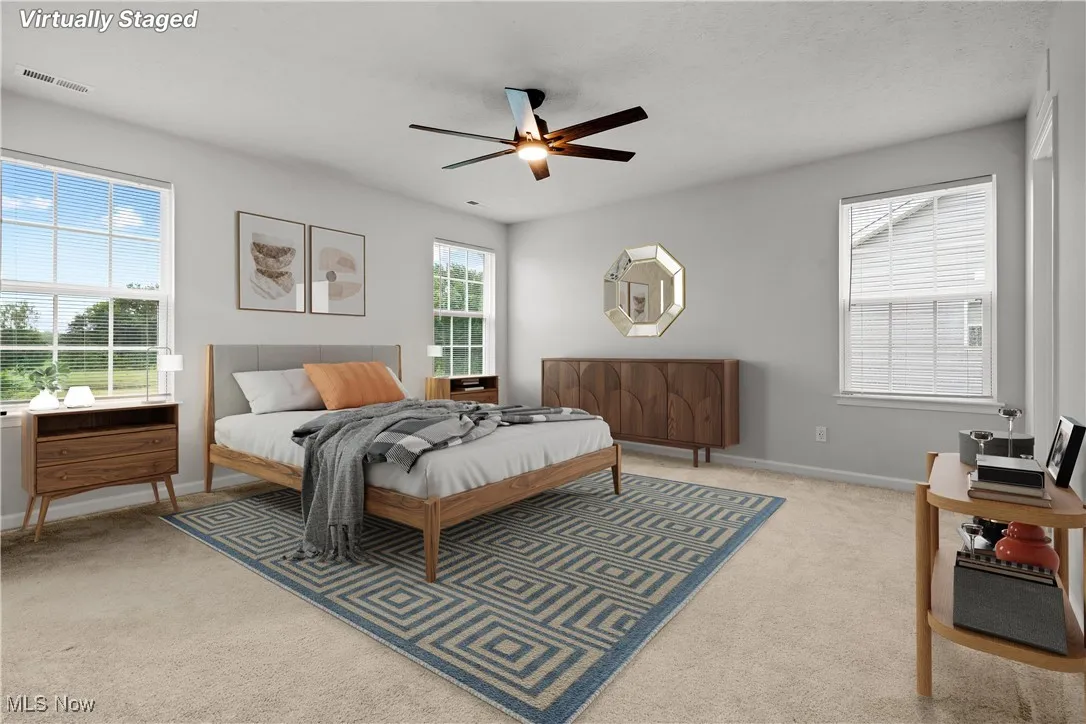 Bedroom featuring light carpet and a ceiling fan