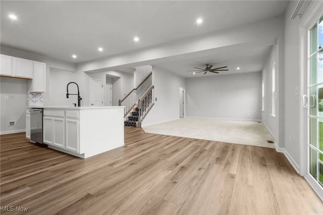 Kitchen featuring dishwasher, white cabinetry, light wood-style flooring, ceiling fan, and recessed lighting