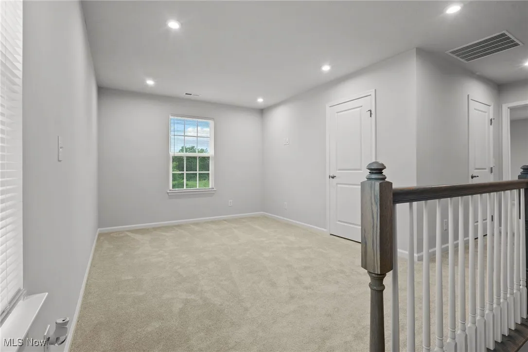 Empty room featuring carpet floors and recessed lighting