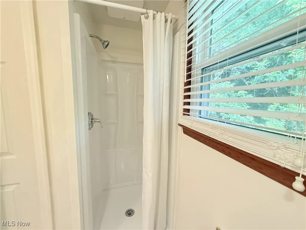 Bathroom featuring a shower stall